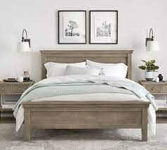 This farmhouse bedroom goes country ranch with the help of a mounted deer sculpture and patterned bedding fit for a cowboy. Farmhouse Bed Wooden Beds Pottery Barn