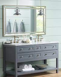 A pair of pendant lights illuminate this bathroom showcasing a vessel sink vanity with chrome fixtures and towel holder along with a wooden framed mirror mounted on the beige wall. Lighting Up The Bathroom With Bathroom Vanity Lighting Ideas Advice Lamps Plus