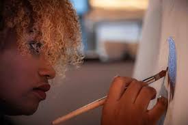 Legally blind artist Stephanie Gowdy creates painting at coffee shop