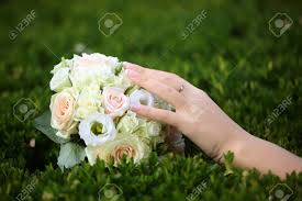 We did not find results for: Closeup View Of One Big Round Beautiful Fresh Wedding Bouquet Of Rose Flowers Pink White And Yellow Pastel Colors Lying On Green Grass Sunny Day Outdoor With Female Hand Horizontal Picture Stock