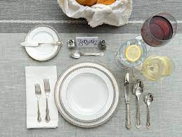 A placemat, cutlery (fork, knife, and spoon), a dinner plate, a water glass, and a napkin. How To Set A Table 3 Ways Basic Casual And Formal Table Settings Hgtv