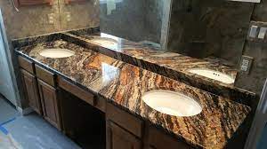 Also known as brown fantasy, this is a light colored granite with white, cool gray and light brown veins and few dark specks, characterized by a beautiful flowing pattern. Blue Fire Granite Bathroom Bathroom Dark Brown Vanity Remodel Dark Granite Granite With Movement Als Granite Bathroom Granite Countertops Countertops