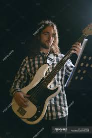 Man Playing Bass In Stage And Looking At Notes Male Action Stock Photo 171159496