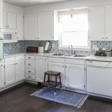 The best way to achieve a distressed look in a flat kitchen is to use sandpaper. Painting Oak Cabinets White An Amazing Transformation Lovely Etc