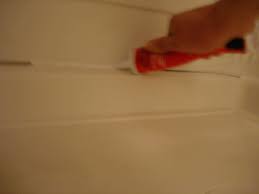 Silicone caulk has good adhesive properties and will not only seal cracks but also hold trim pieces to the wall. How To Caulk A Shower Stall