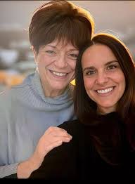 Please could you open my wife's eyes they are brown as she lost her mum  recently and this photo was taken at her sons wedding and was last photo  with her. |