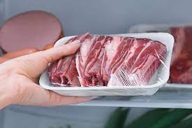 Pork chops on the chopping board, tomatoes and onions How Long Does Pork Last In The Fridge Raw And Cooked Howchimp