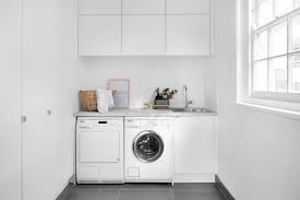 Solid shelf over the washer/dryer and lots of cabinets on side wall make this a great small laundry room layout. Laundry Designs And Ideas Laundry Cabinets Kaboodle Kitchen
