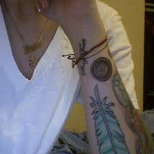 Lil Debbie Button Forearm Tattoo