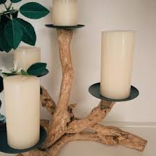 These would be great on a table driftwood comes in all sorts of interesting shapes and sizes, which you can take advantage of by drilling tea light pockets into different levels of the wood. Handmade Driftwood Pillar Holder Pottery Barn