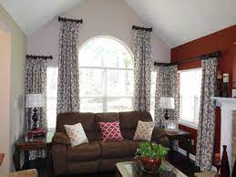 Ring Curtains Of Different Heights Complement These Arch Corner Windows Living Room Windows Living Room Decor Curtains Corner Window Treatments