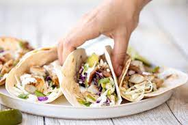 Put container of sour cream and good sized bunch of chopped cilantro into blender, add juice of 1 lime. Easy Fish Tacos With Lime Crema Ahead Of Thyme