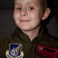 Jaden Terrell, a 7-year-old archery student, knocks,