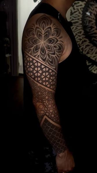 UPPER ARM TATTOO (GEOMETRIC / BLACKWORK) Geometric upper outer arm tattoo featuring layered mandala-inspired symmetry and precision blackwork pattern design. Clean linework, balanced negative space, and structured repetition create a strong visual
