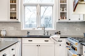 Think white cabinets above the sink paired with shades of blue, black, or brown below. Black White Kitchen Re Do Cara Alyn Interiors