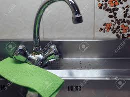 Helps disperse and pool water evenly, can be cut through to accommodate plumbing/pipes and extremely flexible it's also extremely absorbent and a nice addition to protect against under sink leaks or spill in kitchens or vanities. Kitchen Sink With Hot And Cold Water Tap Stock Photo Picture And Royalty Free Image Image 138930178