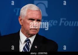 U.S. Vice President Mike Pence, left, watches as his mother Nancy Pence,  wife Karen Pence, and daughter Audrey Pence remove draping to unveil his  portrait during a ceremony at the Indiana Statehouse
