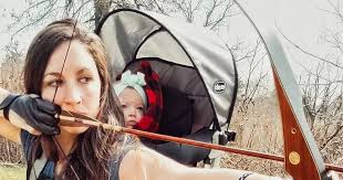 Mum slammed for hunting wild animals with baby daughter strapped to her  back