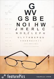 Optometry An Eye Exam Chart Is Blurred In The Background Of A Pair Of Modern Eye Glasses