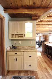It also combines it with a dark teal overhead cabinet, a unique limestone backsplash with stainless steel behind the stove for easy grease cleaning. Log Cabin Rustic White Kitchen Cabinets With Granite And Wood Countertops Rustic Kitchen Cleveland By Cabinet S Top Houzz