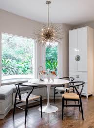 An Arteriors Zanadoo Chandelier Hangs Over An Ikea Docksta Table Seating Hans Wegn Contemporary Dining Furniture Furniture Design Chair Rustic Dining Furniture