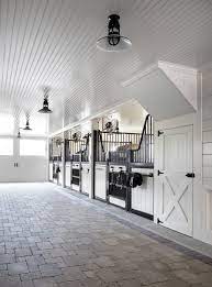 One beautiful brown horse standing in stable at ranch and looking at camera. 12 Beautiful White Stable Interiors Stable Style