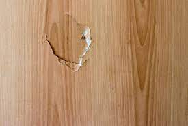 Use the edge of a putty knife to smear and press the mixture over the hole, filling in any gaps and making it roughly flush with the door. How To Fix A Hole In A Door Solid Or Hollow Core Door