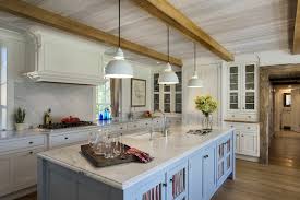 A contemporary kitchen with white cabinetry, a grey kitchen island and wooden detailing plus wooden beams is very cozy. Exposed Wood Beams Country Kitchen Crisp Architects