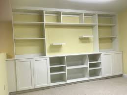 Expertly designed by our houston location to blend seamlessly with the rest of the room, this home office uses adjustable shelving, custom cabinets and storage solutions to create an modern and beautiful space that blends with the client's desk. Home Office Full Wall Cabinets Martin Calloway