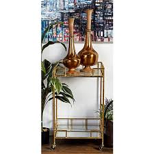 This cart's two spacious mirrored glass shelves provide perfect platforms for storing bottles of spirits and mixing craft cocktails, while four castor wheels offer effortless mobility to serve guests. Harper Willow Contemporary Iron Bar Cart With Gold Finish And Mirrored Two Tiered Design 18 In X 18 In X 30 In 65572 At Tractor Supply Co