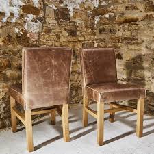 Get up to 70% off now! Low Back Faded Saddle Leather Dining Chair Curiosity Interiors