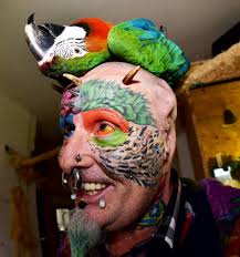 Tattooed Man Has Both Ears Cut Off To Look Like His Pet Parrots