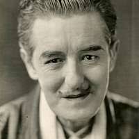 Joseph Berthelot holds his service dog Roxxy after