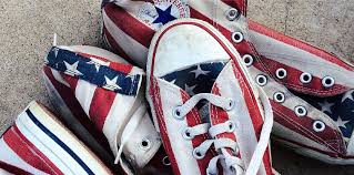 A white circle with a black border surrounding a chevron pointing up. Best Sneaker Brands Made In The Usa Shoe Hero