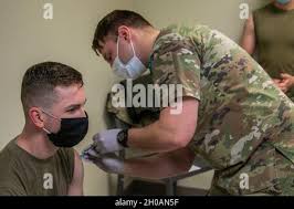 U.S. Army Sgt. Jonah Prescott, combat medic, MEDDAC, Blanchfield Army  Community Hospital, right, gives Sgt. Jacob Settles, combat medic, C  Company, 426 Brigade Support Battalion, 1st Brigade Combat Team,  “Bastogne”, 101st Airborne