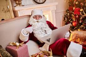 Add extras from santa's workshop (available with purchase of letter): Premium Photo Santa Claus Sitting On Couch And Talking On Mobile Phone Near The Fireplace And Christmas Tree With Gifts