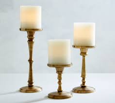 Brass candlesticks and brass candle holders collections of the same brass candlestick style in varying sizes represent a popular design theme. Booker Pillar Candleholders Brass Pottery Barn