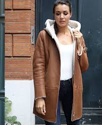Manteau femme sandro • manteau court en peau lainée • encolure arrondie et grand col • manches longues • poches devant • fermeture par boutons milieu devant • le mannequin porte une référence : Peau Lainee Cesare Nori Specialiste Du Cuir Et De La Peau Depuis 1955