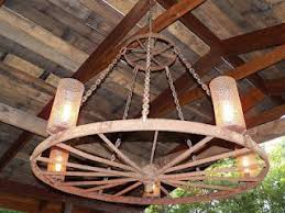 Wagon Wheel Light Fixture Electrical Wiring Welding And Hanging Light Covers Are Made Out Of Old Gutt Wagon Wheel Light Light Fixture Parts Light Fixtures