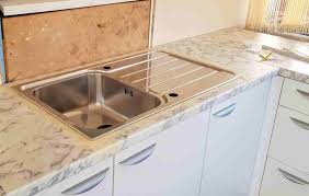 a kitchen sink in a laminate worktop