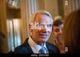 United States Senator Rob Portman (Republican of Ohio), left, and United  States Senator Joe Manchin III (Democrat of West Virginia), right, listen  while United States Senator Bill Cassidy (Republican of Louisiana), center,