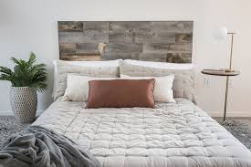 Add architectural interest on the wall behind the bed by applying wood panelling in a grid pattern. How To Easily Upgrade Your Bedroom Design With Wood Wall Planks