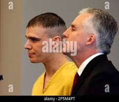 In an April 25, 2011 photo, Levi Chavez, center, in suit, leaves his murder  arraignment in the Valencia County District Court in Los Lunas, N.M. Chavez  is accused of shooting his wife