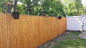 Easy Way To Dress Up A Regular Stockade Fence Just Leave The Posts Long Add A Hook And A Post Cap This Also Stockade Fence Fence Prices Backyard Fences