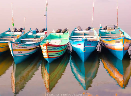 Colorful fishing boats lined up at Wadi sea shore, Kollam.