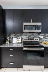 Dark Stained Slab Door Cabinets With A Linear Glass Backsplash For A Modern Look Cabinets Monaco Maple Es Kitchen Cabinets Online Kitchen Cabinets Slab Door