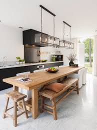 An open kitchen with a cookroom format offering marble top island and stainless steel extends under a vent hood that is fixed over the dark backsplash. Kitchen Design Ideas Long Narrow Novocom Top