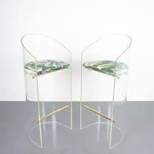 A sleek chrome pedestal base and curvacious seat contribute to the stool's. Charles Hollis Jones Style Pair Of Lucite Brass Bar Stools 1960
