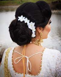 What A Beautiful Large Large Low Bun With Real Flower Gajra Care However Should Be Taken Before Adopting Such Ha Bun Hairstyles Low Bun Hairstyles Hair Styles