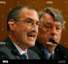 Bruce Rosenblum, managing director, The Carlyle Group, right, testifies